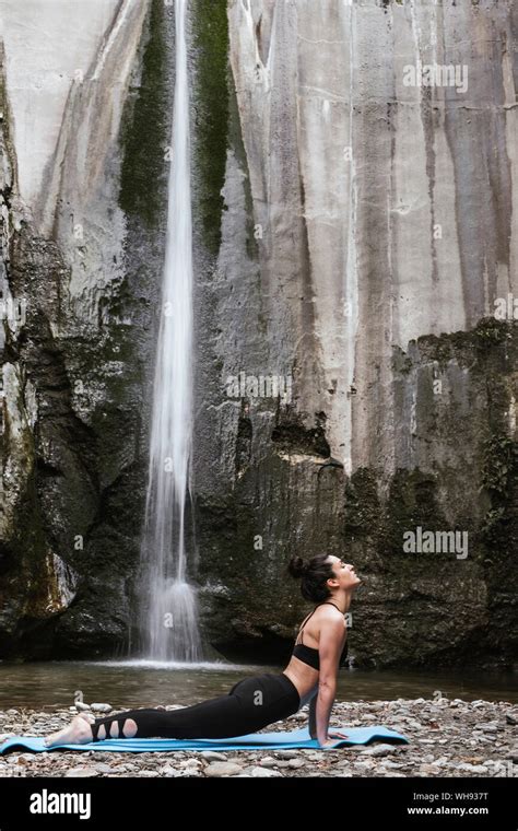 woman practising yoga  waterfall cobra pose stock photo alamy