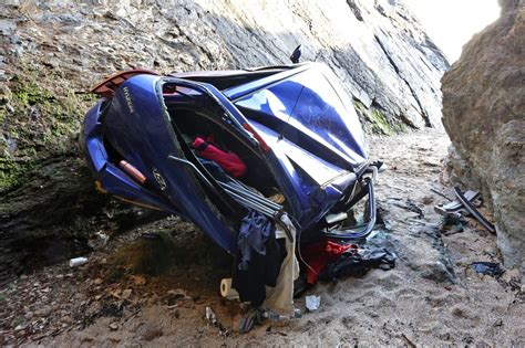 a pensioner reversed his car off a 50ft cliff while waiting to pick up