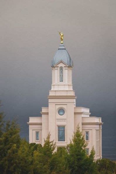 a large white building with a blue roof and a gold statue on top is