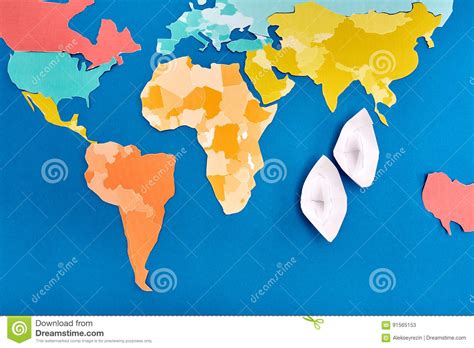 world map cut   colored paper   white paper ship based