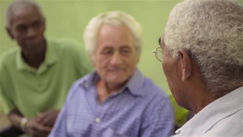active retirement and senior people group of three old male friends talking and laughing on