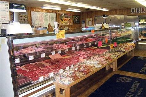 butcher shop filled  lots  meats  veggies  display  front   counter