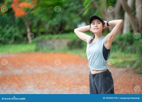 Portrait Of Runner Woman Doing Stretching And Warming Up Her Body