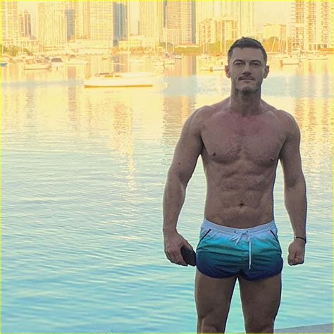 luke evans goes shirtless in tiny shorts at the beach