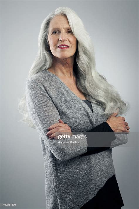 mature woman with long gray hair standing photo getty images
