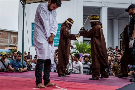indonesian gay couple caned 85 times each in front of huge jeering