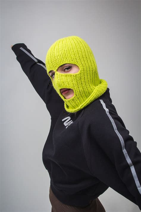 woman  black jacket  yellow ski mask photo  apparel image  unsplash