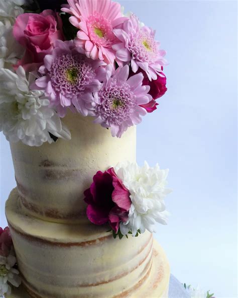 semi naked wedding cake with fresh flowers karen s cakes