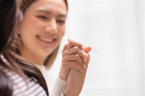 Close Up Hand Of Two Female Holding Hands Two Girls Sitting On Bed Hand