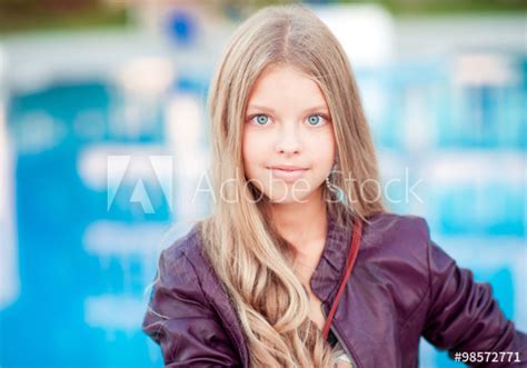 smiling blonde teenager girl 12 15 year old posing over