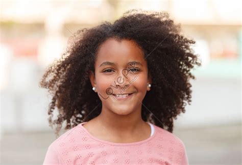 Cute African American Girl Smiling In The Street With Afro Hair Picture