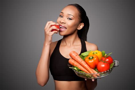 happy healthy black asian woman eating vegetables tamborello dental