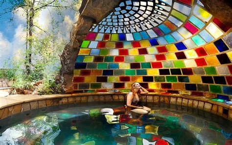 woman  sitting   middle   pool  colorful tiles   walls