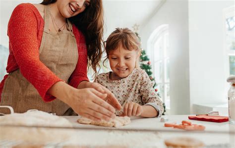 Mother Teaching Daughter To Make Cookies For Christmas 132876