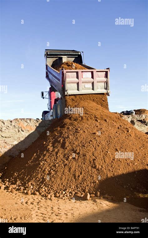 dump truck dumping fill dirt  excavated basement   residential houses stock photo alamy