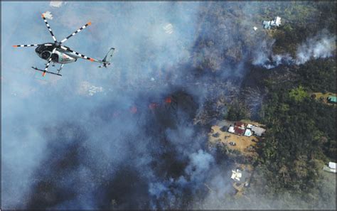 A Helicopter Flies Above Destruction Amid Advancing Lava