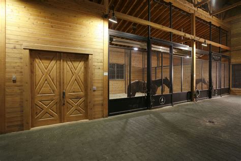 building   horses standing   stalls  doors