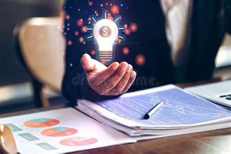 businessman hand holding light bulb knowledge finance stock photo