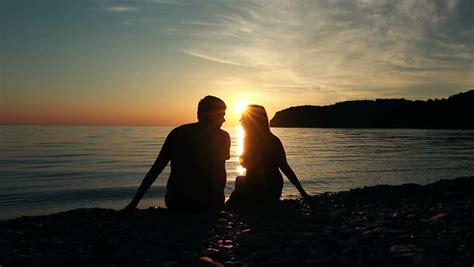 man hugging woman at romantic date couple looking at amazing sunset together stock footage