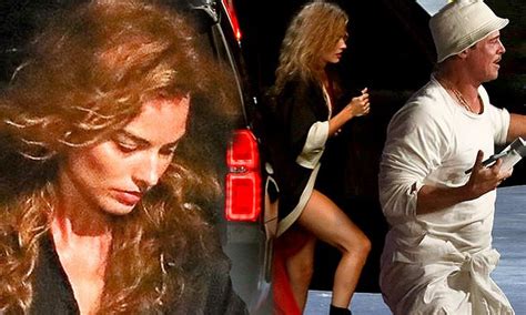 Margot Robbie Puts On Very Leggy Display In Robe While Arriving On La