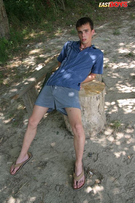 twink in flip flops and shorts strips naked in the forest and models his sexy dick