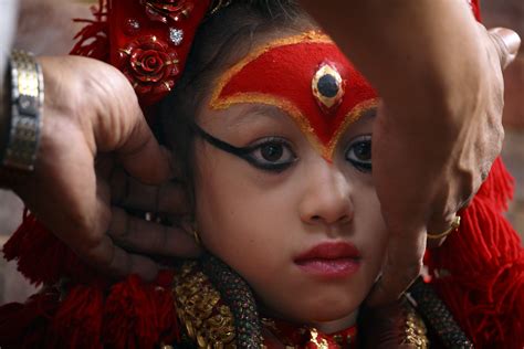 A Priest Covers Living Goddess Kumari’s Ear As The Nepal Army Fires A