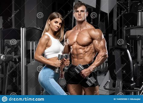Sporty Couple Showing Muscle And Workout In Gym Muscular Man And Woman