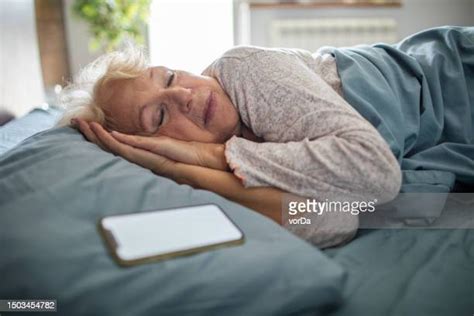 Mature Woman Sleeping On Couch Photos And Premium High Res Pictures