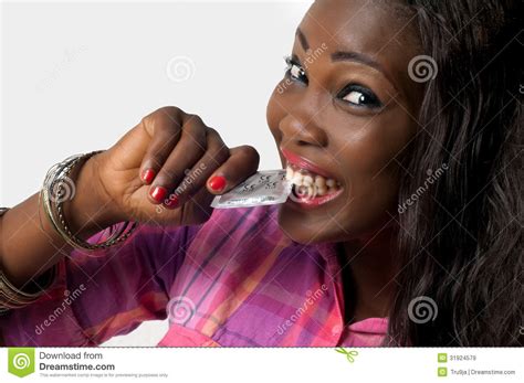 african american girl biting condom safe sex stock image