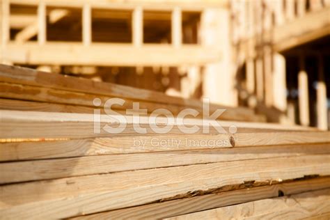 stacks of lumber boards at construction framed building b