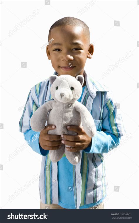 boy holding stuffed toy smiling portrait stock photo