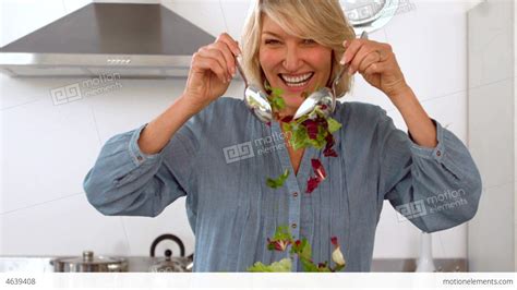 smiling woman tossing her salad stock video footage 4639408