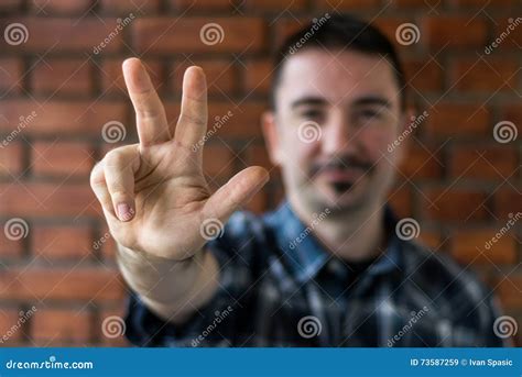 young man    showing  fingers selective focus stock image image  shirt beard