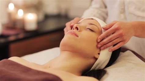 woman having face and head massage at spa 10 by dolgachov videohive