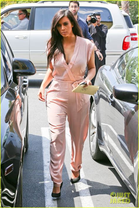 kim kardashian rocks light pink jumpsuit with partially sheer back
