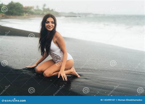 Side View Of Girl In Bikini Spends Time On Black Sand Beach Young