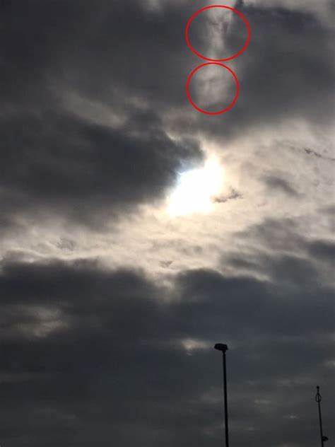 solar eclipse woman captures mystery face in cloud after taking