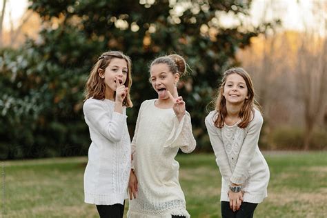 three sister doing silly poses together by stocksy contributor jakob