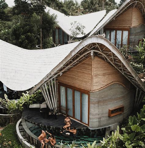 undulating bamboo roofs wrap  wellness retreat   lush forest  bali