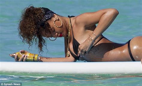 rihanna bares her body in a g string bikini while sunbathing on a