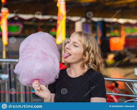Spanish Blonde Woman Eating Sweet Cotton Candy In The Entertainment