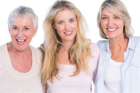 Three Generations Of Cheerful Women Smiling At Camera