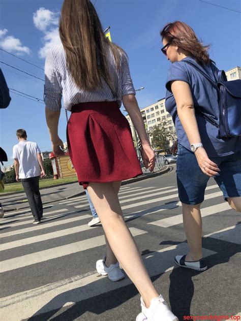 girl in a skirt with sexy skinny legs on the crosswalk candid photos