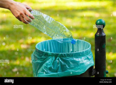 hand  woman throwing plastic bottle   trash  concept  environmental protection