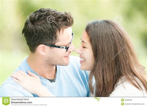 Pretty Woman And Man In Glasses Kissing In Park Stock