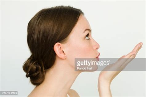Young Woman Blowing Kiss Side View Photo Getty Images