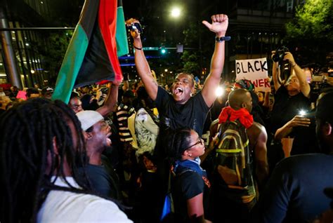 a man shouts at the intersection of trade and college streets during a protest against the