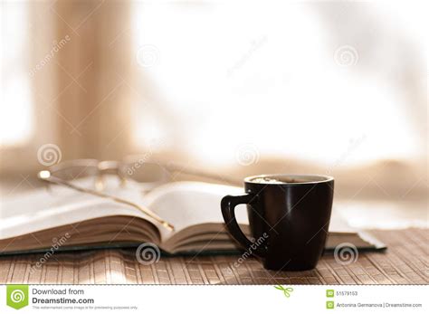 Cup Of Coffee Glasses Rest On The Open Book Against Stock