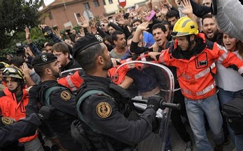 spanish police clash with catalan voters smash way into