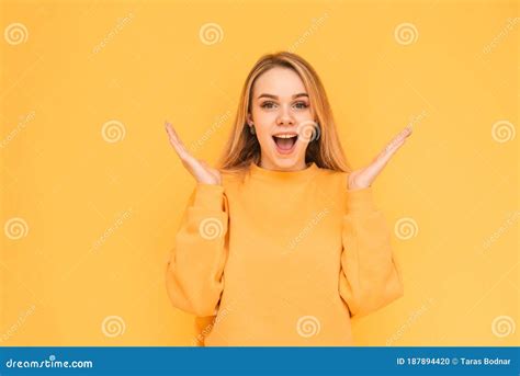 Portrait Of A Teenage Girl With A Shocking Face Wearing Orange Clothes